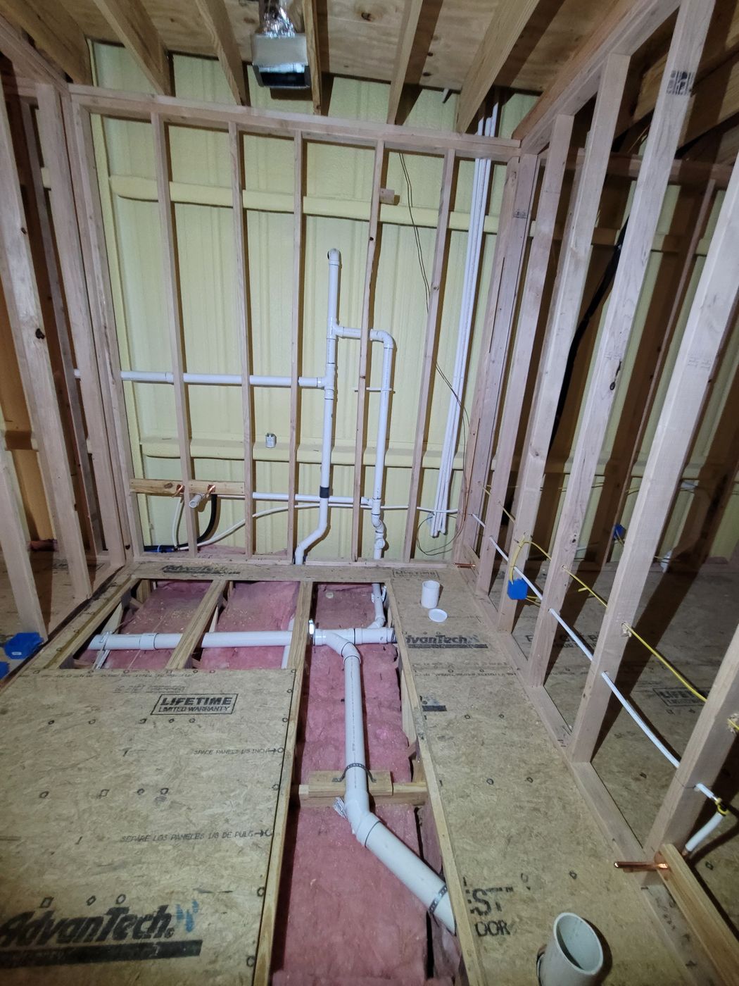 Drain, waste and vent rough-in running through floor framing and walls at Patriot Academy