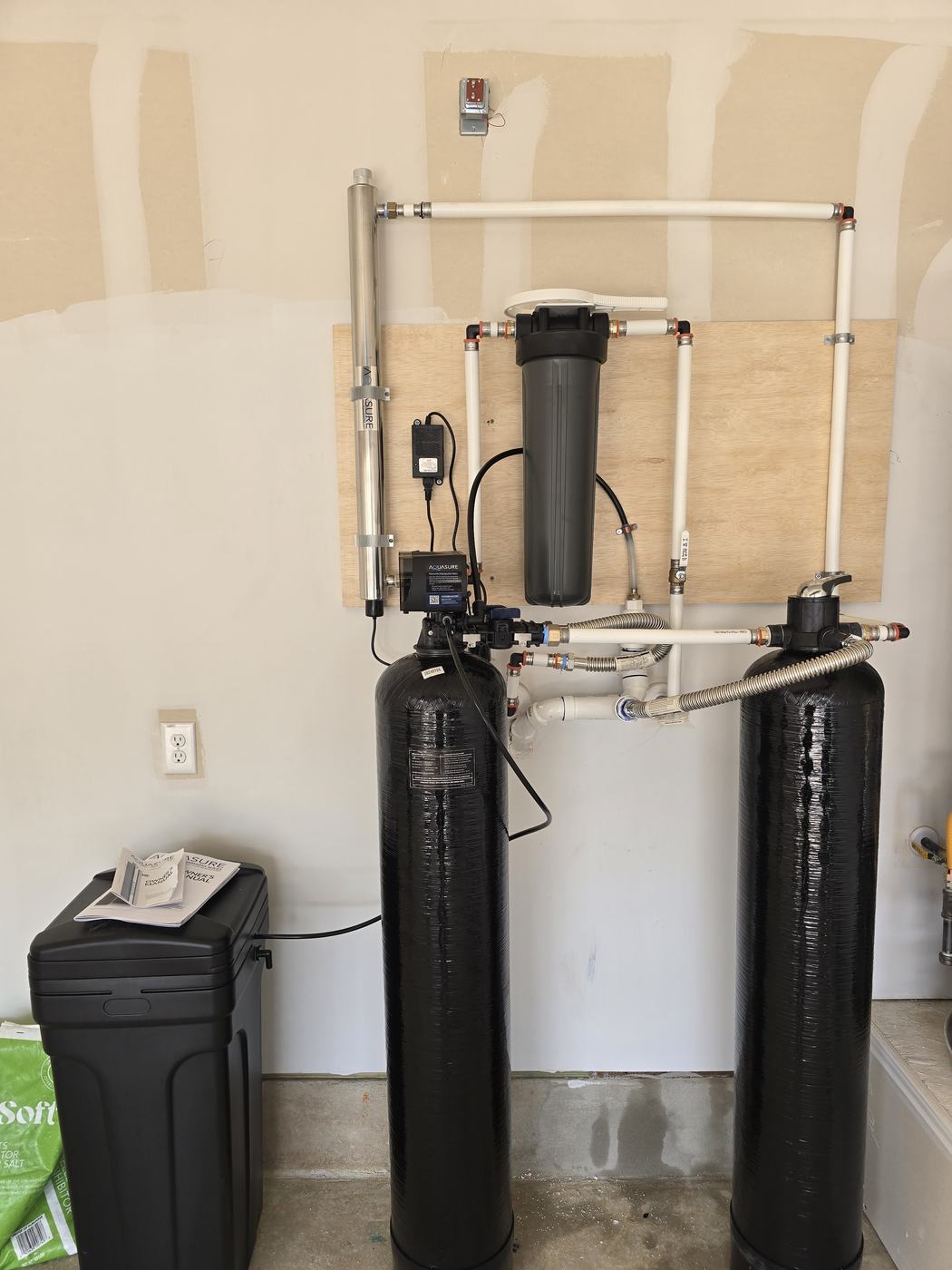 Whole-house water treatment installation: softener, carbon filter, UV and sediment filtration